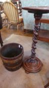 Brass studded stained wood barrel with studded straps and walnut jardiniere stand with spirally