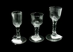 Three old English wine glasses, with cut faceted stems, raised on circular foot (3)
