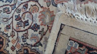 Persian style wool rug, cream ground with foliate central medallion and foliate borders, in beige