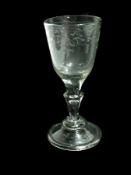 Old English wine glass with foliate engraved funnel bowl, on tapering pedestal stem, on a raised