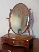 Late 18th/early 19th century inlaid mahogany toilet mirror, the oval plate on scroll supports,