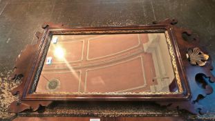 Chippendale style mahogany wall mirror with scroll and gilt foliate pediment