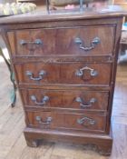 Reproduction mahogany small chest of four drawers, on bracket feet