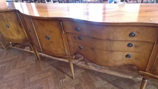 Modern yew drinks cabinet, bow-fronted on turned supports, matching serpentine-fronted sideboard