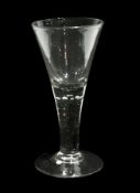 Large Georgian wine glass with drawn trumpet bowl, raised on a conical foot, the bowl decorated with