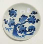 Three early 20th century Japanese blue and white chargers depicting peonies in vase, buildings in