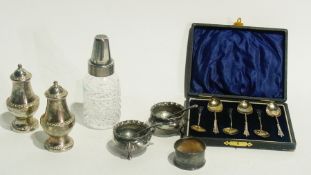 A boxed set of silver coffee spoons,cut glass bottle with silver coloured metal collar holding a