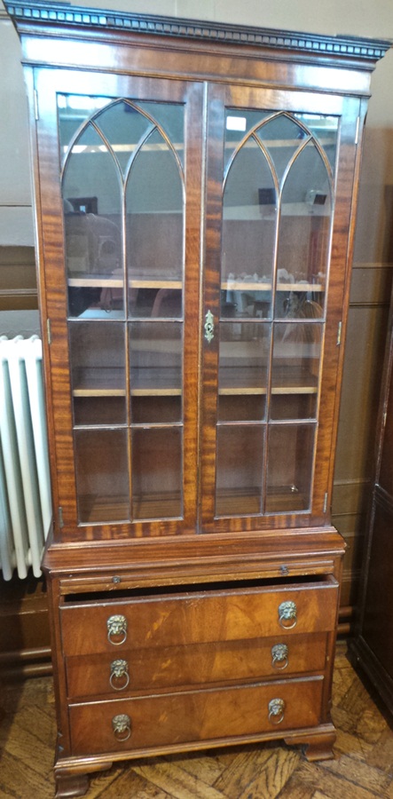 Small mahogany library bookcase with dentil cornice, pointed arch astragal doors, brushing slide and