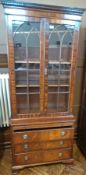 Small mahogany library bookcase with dentil cornice, pointed arch astragal doors, brushing slide and