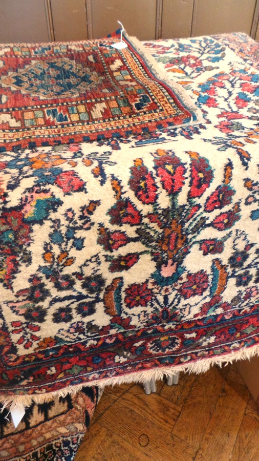 Persian wool rug, the ivory ground allover with floral and foliate sprays in polychrome colours