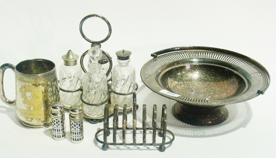 Silver plated condiment set with cut glass bottles, EPNS cake basket with handle, a mug, toast rack,
