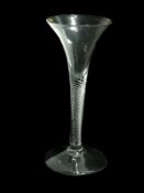 Old English wine glass with trumpet bowl, multiple spiral air-twist stem, raised on a circular foot,