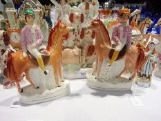 Pair of Staffordshire flatbacks of jockeys on horses, 23cm high and a pair of spaniels, one seated