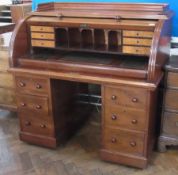 Victorian mahogany cylinder desk, the top with ogee mould raised edge, the cylinder opening to