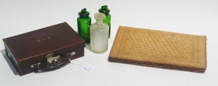 Small leather suitcase, four green glass medicine jars, leather writing folder, table brush, etc.