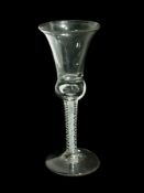 Old English wine glass with waisted bell bowl, four spiral threads outside central gauze, raised