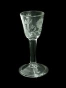 Old English wine glass with drawn trumpet stem, engraved floral pattern, raised on a circular folded