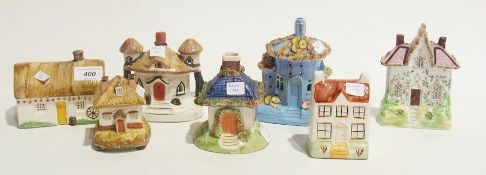 Seven various Staffordshire models of cottages including pastille burners and money boxes