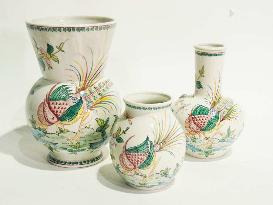 Set of three Portuguese graduated and variously shaped pottery vases with exotic bird and