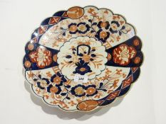 Japanese Imari plate with frill rim, of typical design together with another with central fan-type