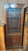 Polished wood cabinet with display section to top and cupboard below