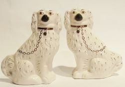Pair of Staffordshire flatback models of King Charles Spaniels, yellow eyes, black nose, bronze/gold