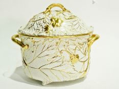 Pottery two-handled warming dish and cover with allover raised gilt scrolling vine decoration and
