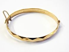 Rolled gold faceted bangle and an amethy