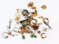 An assortment of yellow metal and other earrings