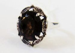 A dress ring set with topaz stone with silver shank