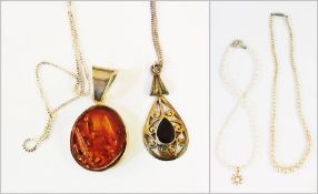 Two simulated/cultured pearl necklaces and two silver neck chains, one with pendant and an amber