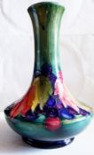 A Moorcroft grape and leaf design narrow neck vase, signed "W Moorcroft", 15cm (circa 1930)