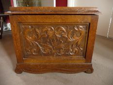 A late 19th century oak ice box/wine cooler carved acanthus leaf scrolls and having shaped apron and