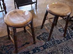 A pair antique oak stools, circular with turned supports, united by stretchers (2)