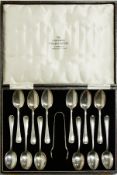 A set of twelve George V silver coffee spoons, rat-tail pattern, with a matching pair of sugar