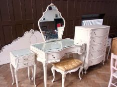 A 20th century Maples bedroom suite, comprising:- mirrorback dressing table, chest of five long