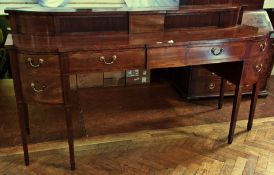 A George III mahogany sideboard, having raised breakfront top with pair sliding tambour doors,