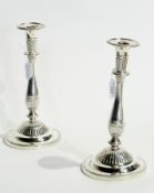 A pair George III silver candlesticks with reeded borders, baluster column, raised on a reeded
