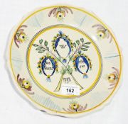 18th century French faience dish, painted in aubergine, yellow ochre, blue and green with "les