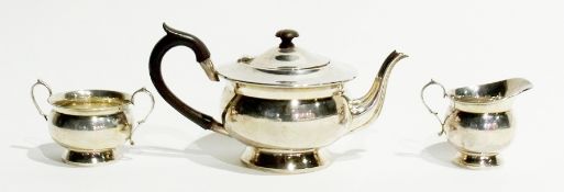 A George V three-piece silver teaset of plain form, comprising teapot with turned ebony finial and
