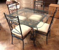 A modern garden table and chairs, the table with square glass top, on cast iron base with cabriole