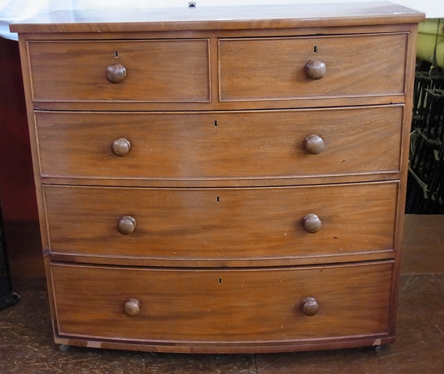 A Victorian bowfront mahogany chest of two short and three long drawers, wood turned handles, on
