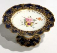 Royal Crown Derby porcelain comport with blue and gilt wavy border, painted floral spray