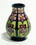 Moorcroft pottery "Violet" vase, baluster-shaped having violet-coloured stylised flowers with