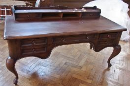 A painted stained pine kneehole desk, with pair of pigeonholes and drawers to desk top, an