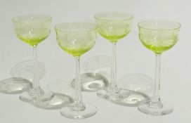 Set of four Art Nouveau engraved wine glasses, green glass bowls with clear glass stems and bases,