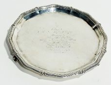 A George V silver waiter with beaded wavy edged border, raised on claw and ball feet, Birmingham