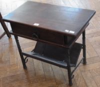 A modern oak side table, with frieze drawer, metal hoop handle, to magazine rack below on metal