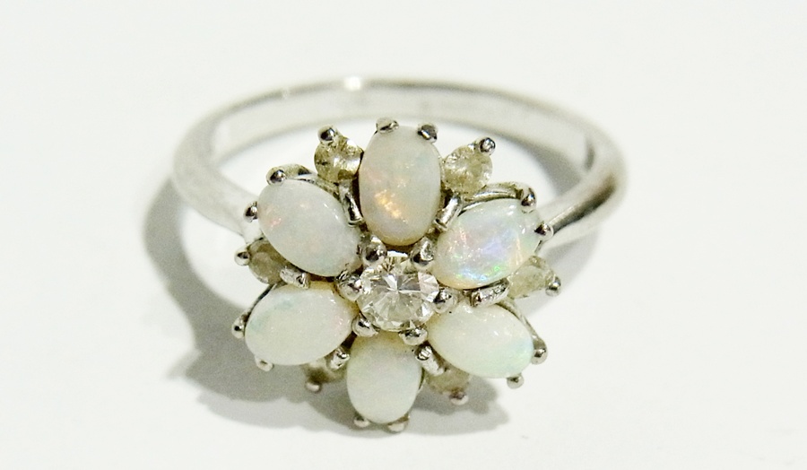 18ct white gold, opal and diamond cluster ring, the central diamond surrounded by six oval opals and