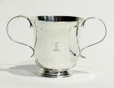 A late 18th century silver two-handled cup, with flared rim, reeded handles raised on a circular